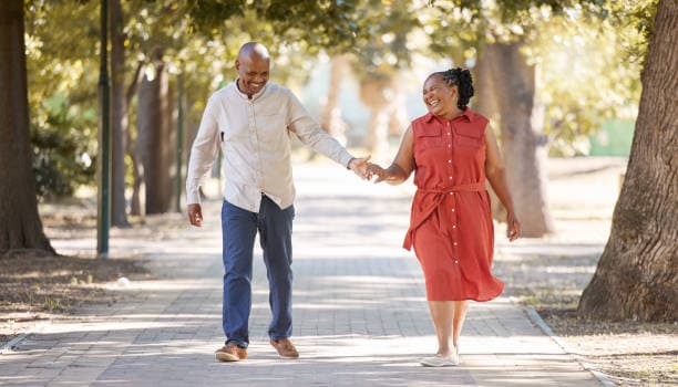 Couple holding hands and smiling together on a walk