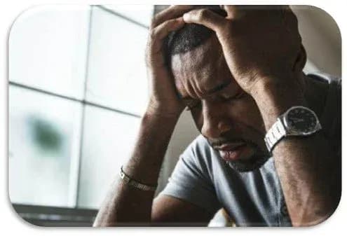 A man deeply stressed and thinking while his eyes are closed