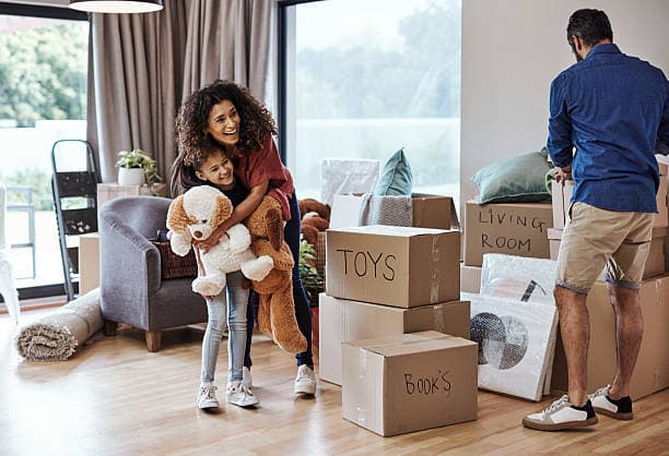 Family unpacking moving boxes in a new Maple Grove home