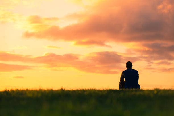 Person reflecting quietly, illustrating the difference between stress, anxiety, and burnout