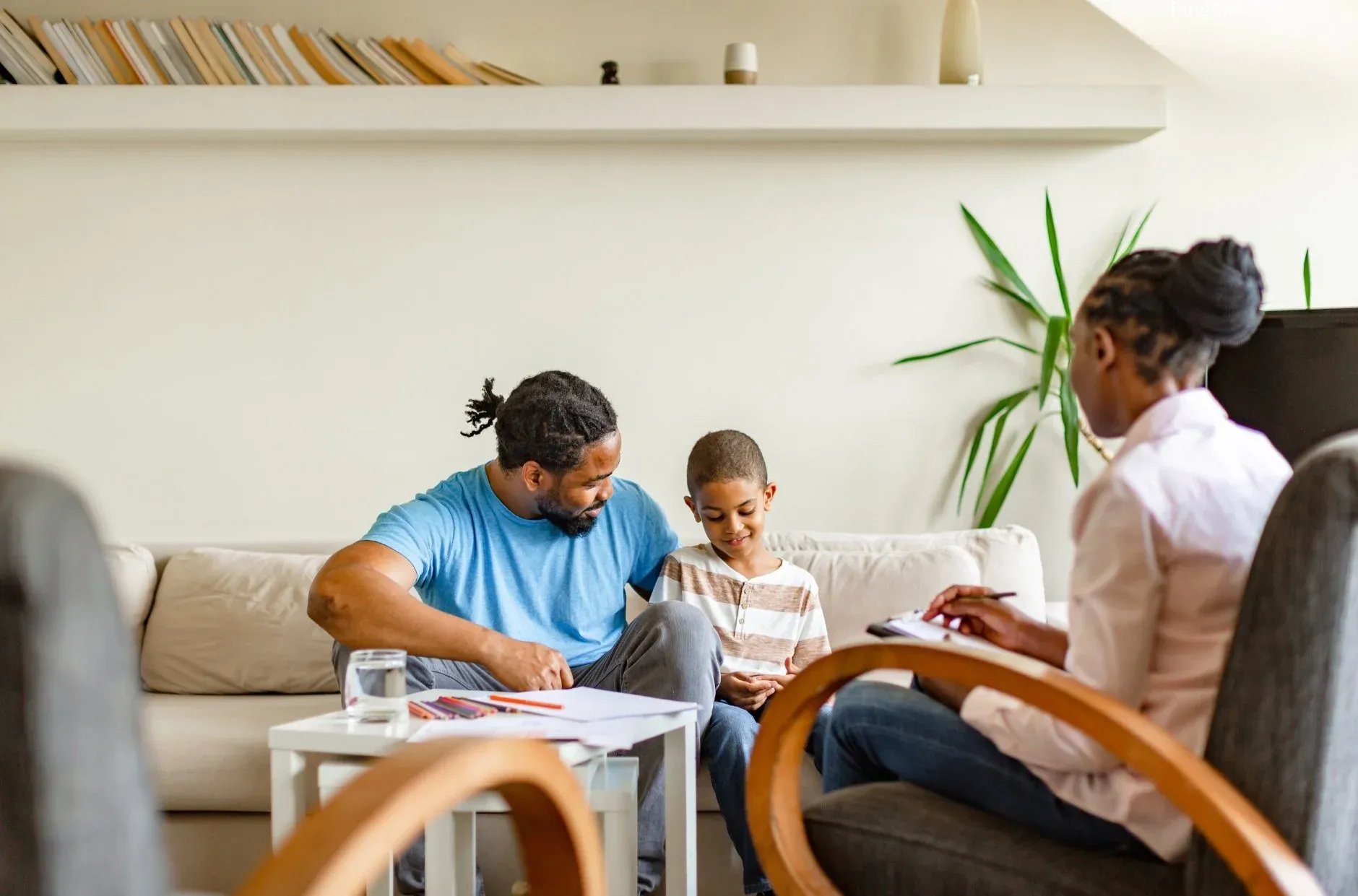 Therapist and child sitting together in a calm therapy room during a trauma therapy session