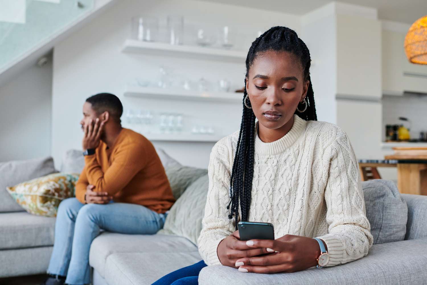 Two people sitting together on a couch, one offering quiet support to the other.jpg