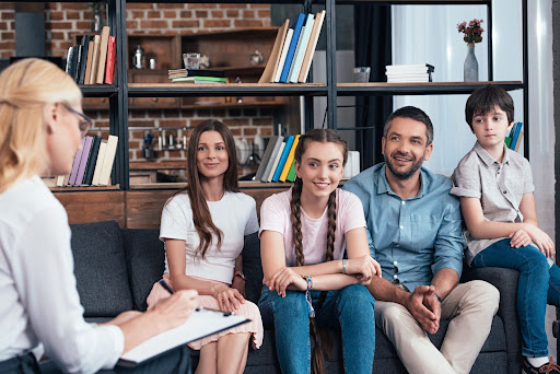 Family of four sitting together during a family therapy session