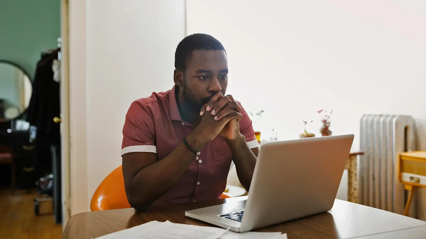 Person researching therapists online on a laptop at home